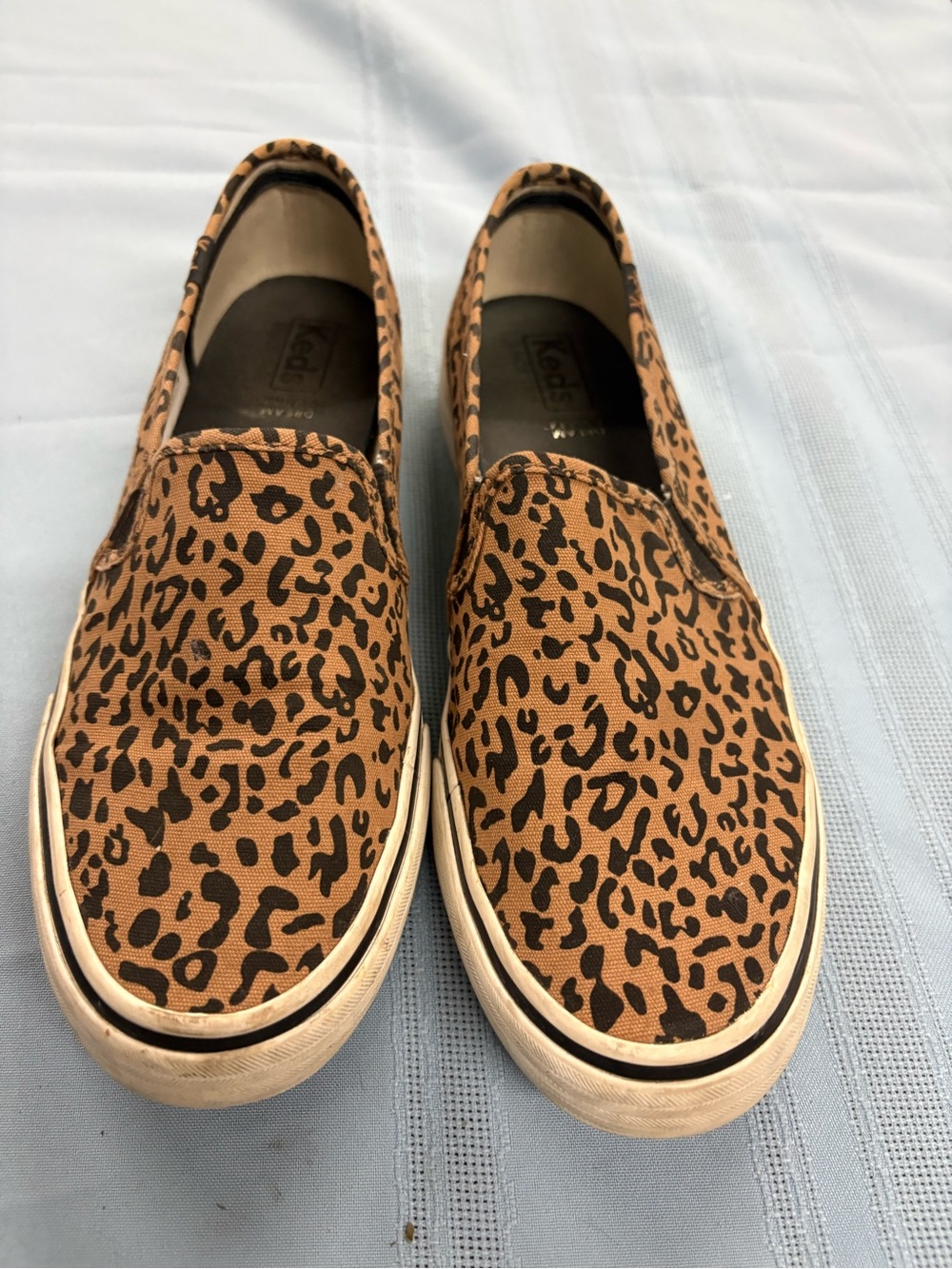 Keds Leopard Print Slip-On Sneakers in Brown and Black